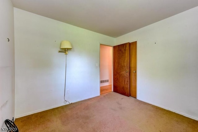unfurnished bedroom featuring carpet floors, baseboards, and visible vents