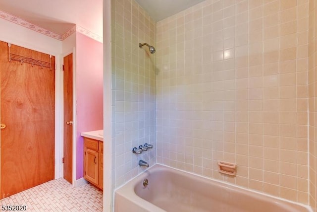 full bath with shower / bath combination, tile patterned floors, and vanity