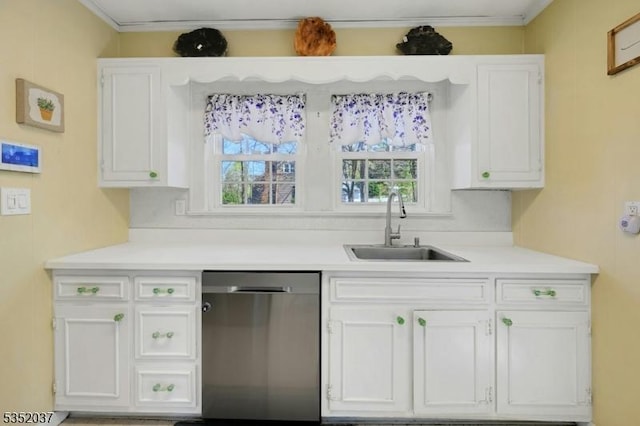 kitchen with stainless steel dishwasher, a sink, white cabinetry, and a healthy amount of sunlight
