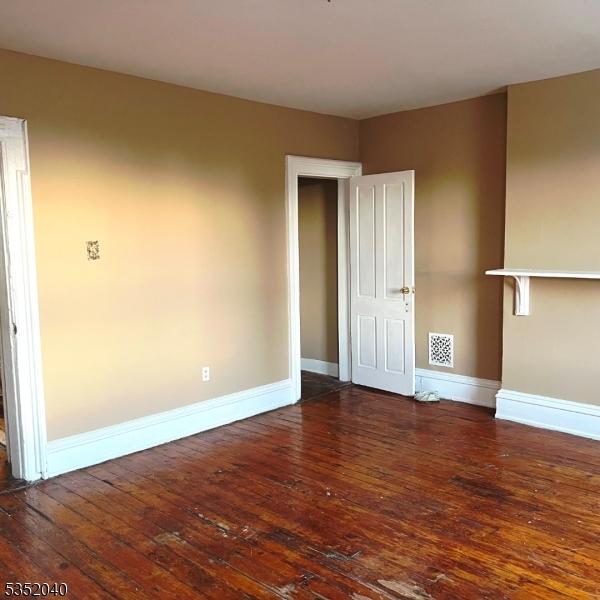 589 Dr Martin Luther King Jr, Newark City, NJ 07102 - empty room with baseboards, hardwood / wood-style floors, and visible vents