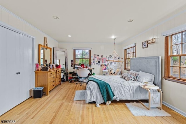bedroom with crown molding, light wood-style floors, and recessed lighting