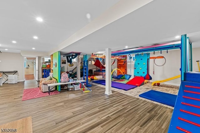 game room with baseboards, wood finished floors, and recessed lighting