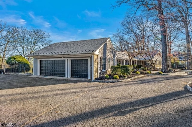 view of home's exterior featuring fence and an attached garage