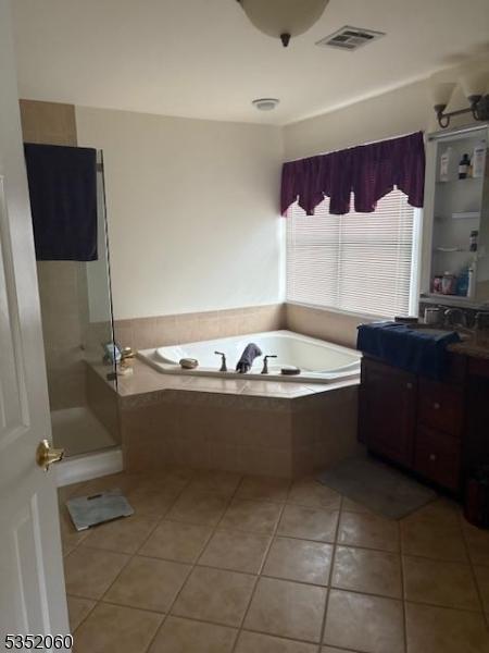 601 Buhler Ct, Pine Beach Boro, NJ 08741 - full bath featuring a bath, vanity, tile patterned floors, and a shower stall