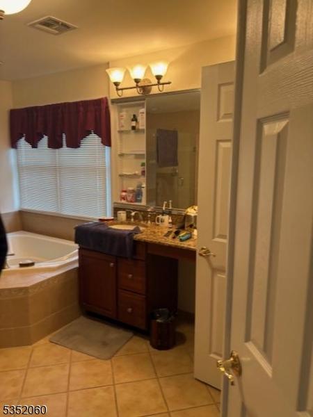 601 Buhler Ct, Pine Beach Boro, NJ 08741 - bathroom with vanity, tile patterned flooring, a garden tub, and a chandelier