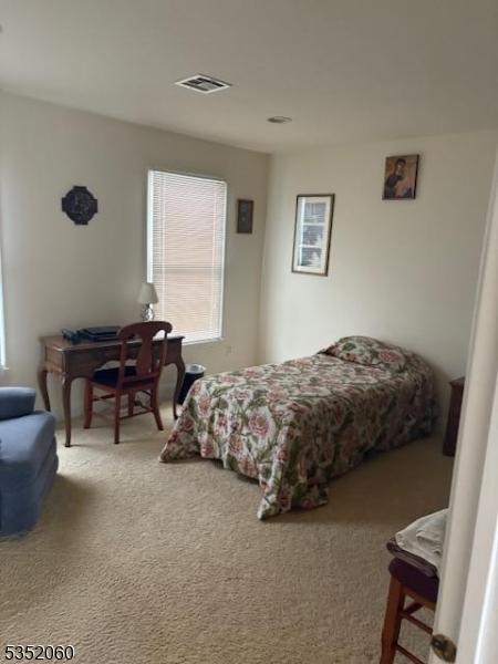 601 Buhler Ct, Pine Beach Boro, NJ 08741 - bedroom featuring multiple windows and carpet
