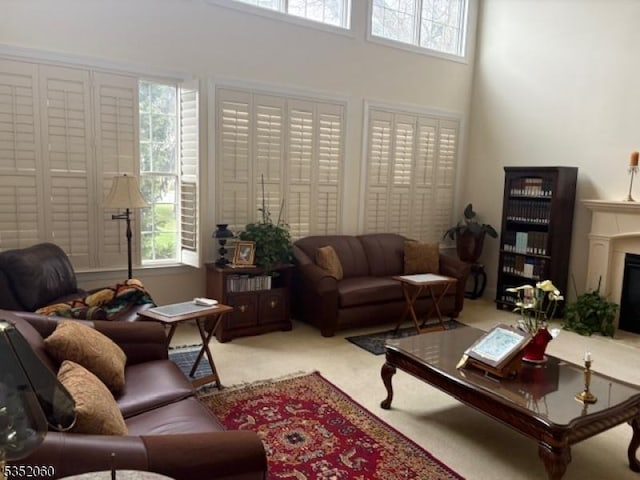 601 Buhler Ct, Pine Beach Boro, NJ 08741 - living room featuring carpet, healthy amount of natural light, a fireplace, and a high ceiling