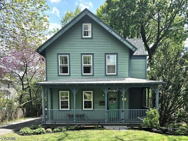 view of front of house featuring covered porch and a front lawn