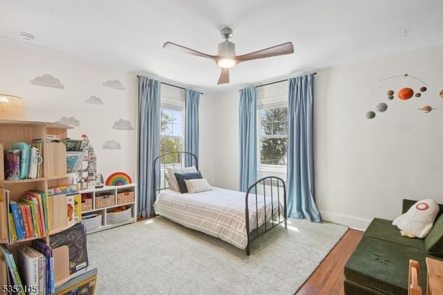 bedroom with ceiling fan and wood finished floors