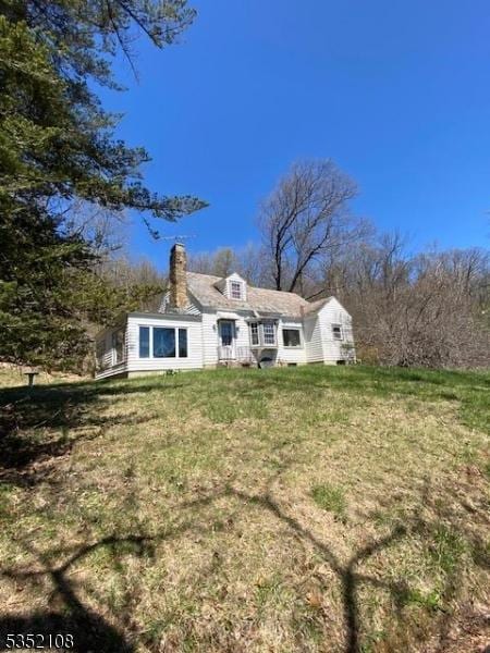28 Dogwood Ln, Washington Twp, NJ 07882 - back of house with a chimney and a yard