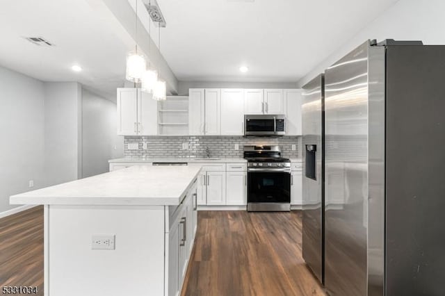 kitchen featuring dark wood-style floors, stainless steel appliances, open shelves, visible vents, and a sink