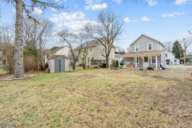view of yard featuring a storage shed, covered porch, and an outdoor structure