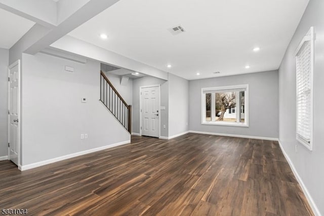 unfurnished living room featuring dark wood finished floors, baseboards, visible vents, recessed lighting, and stairs