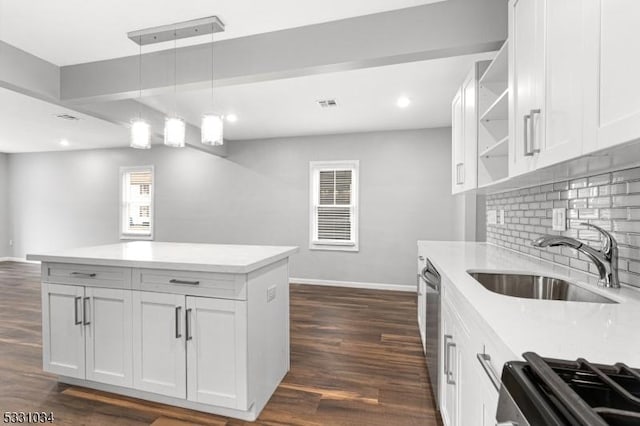 kitchen featuring open shelves, backsplash, a sink, baseboards, and range