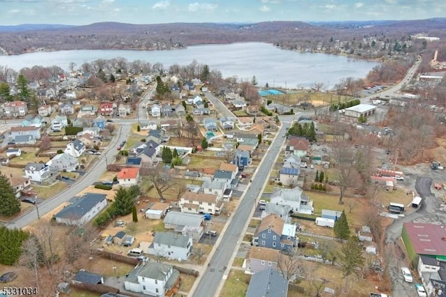 drone / aerial view featuring a water view and a residential view