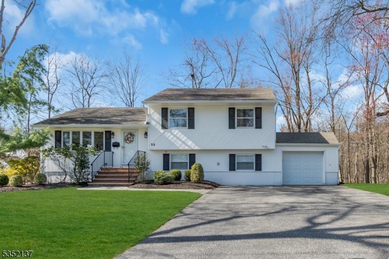 59 Magnolia Pl, Wayne Twp, NJ 07470 - split level home featuring a garage, aphalt driveway, and a front yard