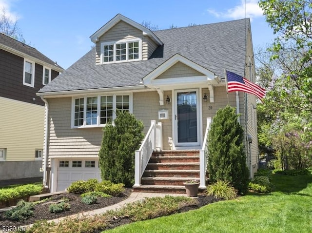 bungalow-style home featuring a garage, a shingled roof, and a front lawn
