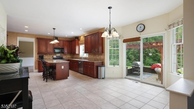 5 Dege Farm Rd, Tewksbury Twp, NJ 07830 - kitchen featuring black microwave, stainless steel dishwasher, stove, a kitchen bar, and decorative backsplash
