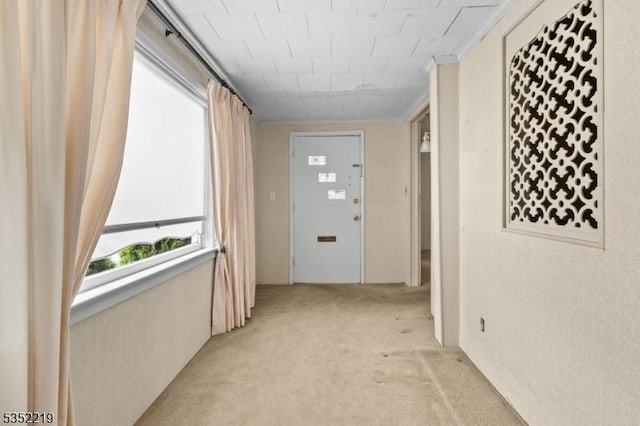 corridor featuring light colored carpet