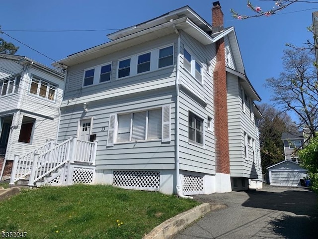 13 Boyden Pkwy, Maplewood Twp, NJ 07040 - view of side of home featuring a lawn, a chimney, and a detached garage