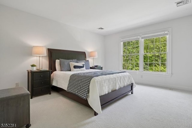 bedroom featuring light carpet