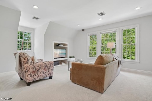 living room featuring light colored carpet, baseboards, and recessed lighting