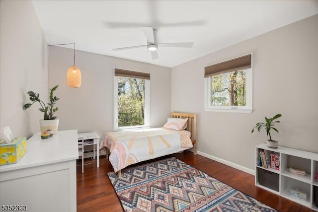 bedroom with baseboards, a ceiling fan, and dark wood finished floors