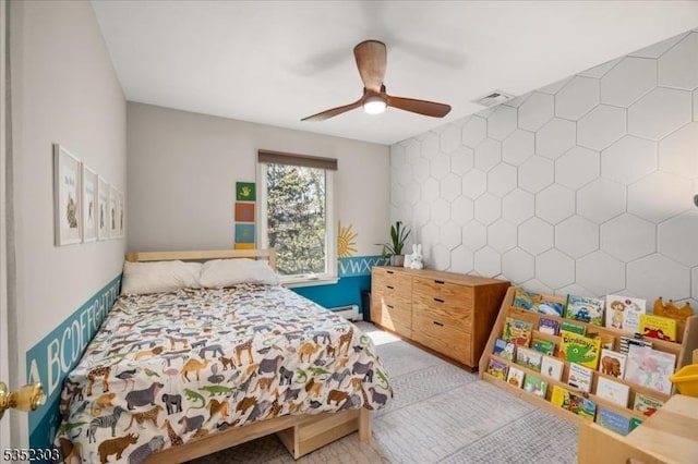 carpeted bedroom with visible vents, ceiling fan, and a baseboard heating unit