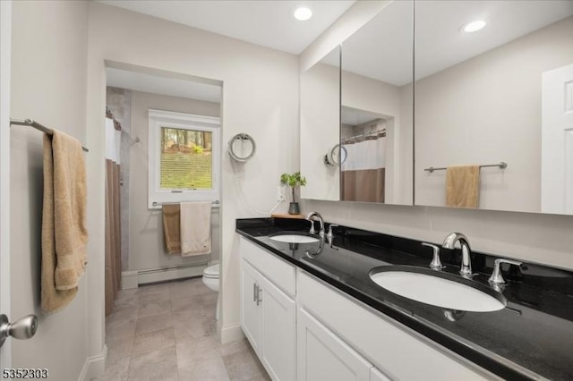 full bathroom featuring a shower with shower curtain, baseboard heating, toilet, and a sink