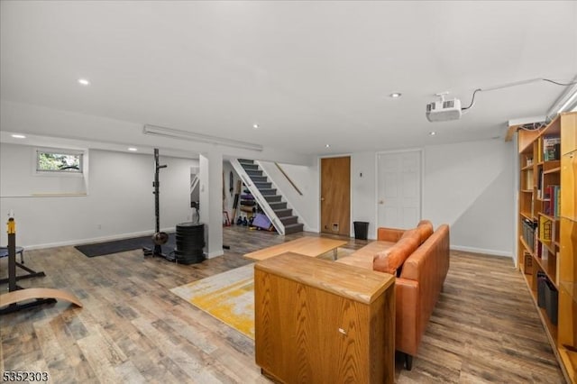 living area featuring a dry bar, stairs, recessed lighting, baseboards, and wood finished floors