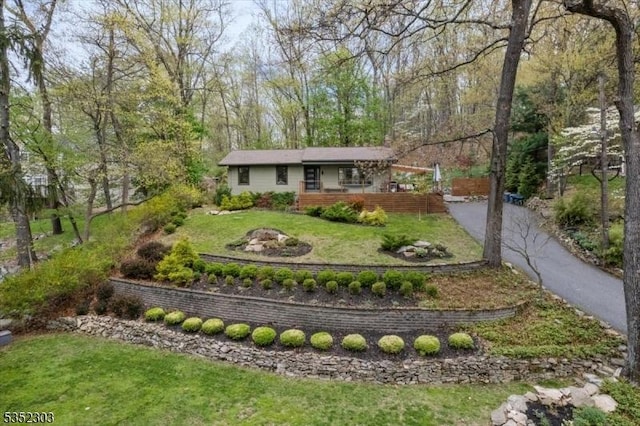 view of front of home with a front yard and aphalt driveway
