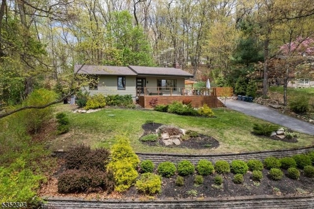 single story home with a chimney and a front yard