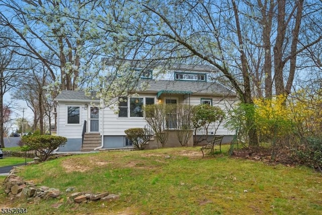 view of front of home with a front yard and entry steps