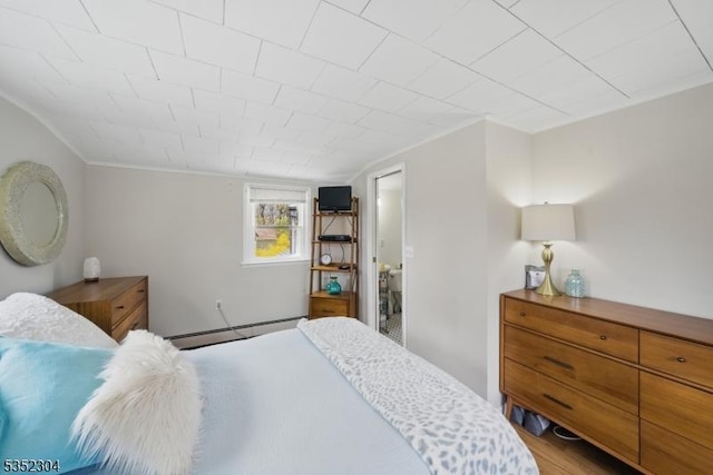 bedroom with crown molding and a baseboard radiator