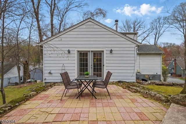 rear view of house featuring a patio and outdoor dining area
