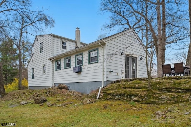 view of property exterior featuring a chimney