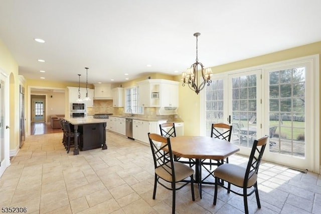 82 Queen Anne Dr, Bernards Twp, NJ 07920 - dining area with stone finish flooring, an inviting chandelier, recessed lighting, and a healthy amount of sunlight
