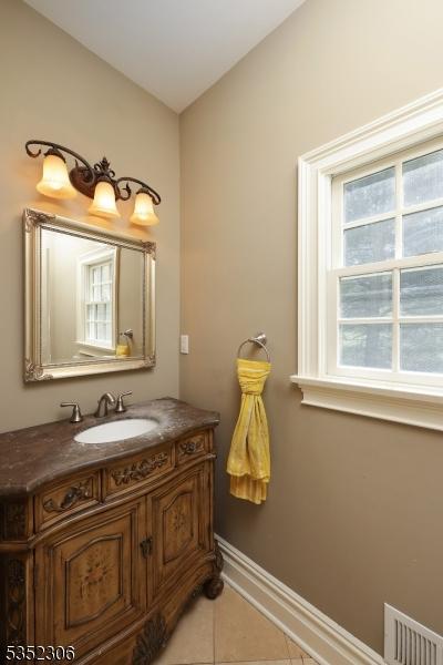 82 Queen Anne Dr, Bernards Twp, NJ 07920 - bathroom featuring baseboards, visible vents, vanity, and tile patterned floors