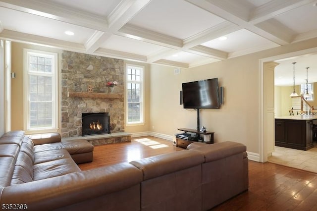 82 Queen Anne Dr, Bernards Twp, NJ 07920 - living room featuring beam ceiling, baseboards, coffered ceiling, wood finished floors, and a stone fireplace