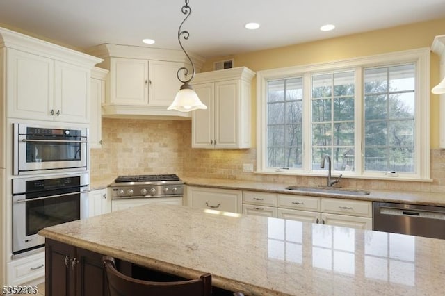 82 Queen Anne Dr, Bernards Twp, NJ 07920 - kitchen featuring light stone countertops, a wealth of natural light, a sink, and appliances with stainless steel finishes