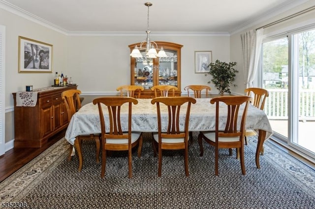 dining space with baseboards, ornamental molding, dark wood-style flooring, and a chandelier