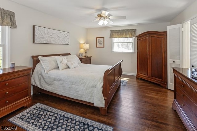 bedroom featuring baseboards, a ceiling fan, and dark wood-style floors