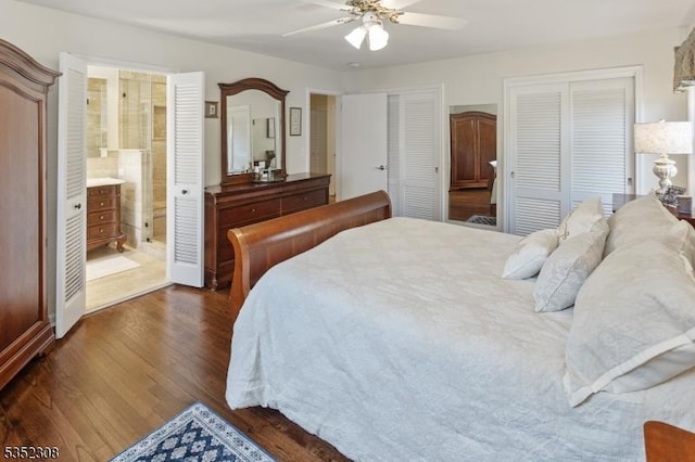 bedroom with ceiling fan, two closets, and dark wood-style floors