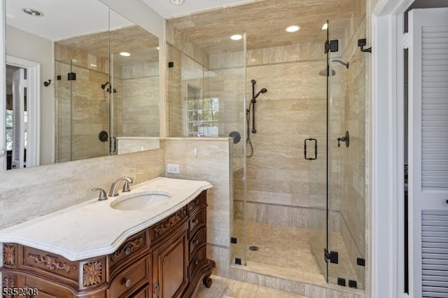bathroom with vanity and a stall shower