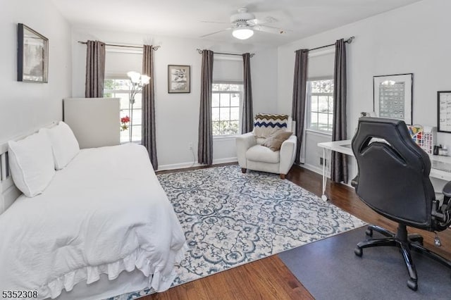bedroom featuring baseboards, ceiling fan, and wood finished floors