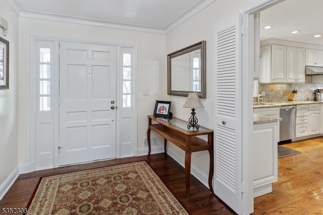 entrance foyer featuring crown molding, baseboards, light wood-style floors, and recessed lighting