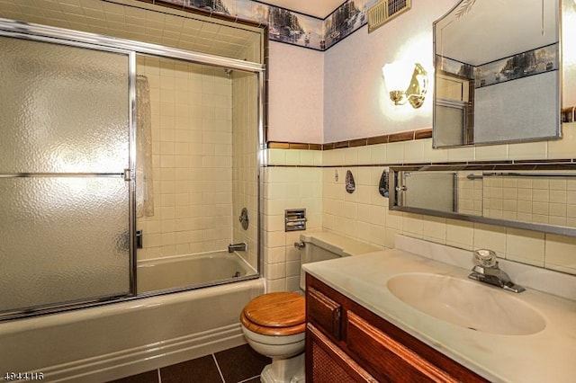 1775 Sleepy Hollow Ln, Plainfield City, NJ 07060 - full bath featuring toilet, shower / bath combination with glass door, vanity, tile walls, and tile patterned floors
