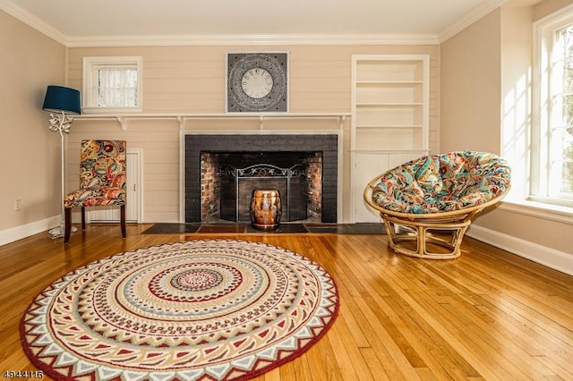 1775 Sleepy Hollow Ln, Plainfield City, NJ 07060 - sitting room featuring wood-type flooring, a fireplace, baseboards, crown molding, and plenty of natural light