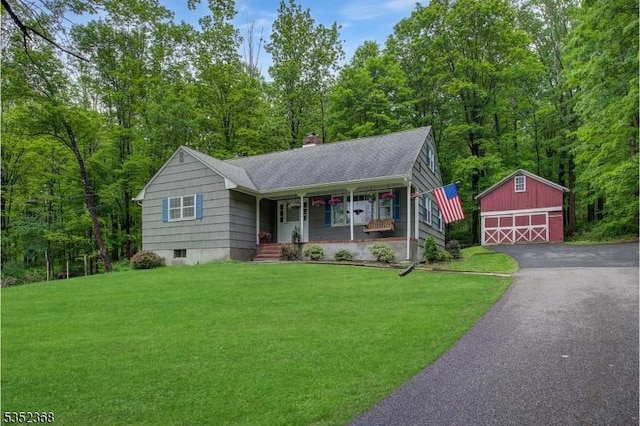 58 Water St, Tewksbury Twp, NJ 08833 - view of front of property featuring an outbuilding, a porch, a detached garage, a front yard, and a chimney