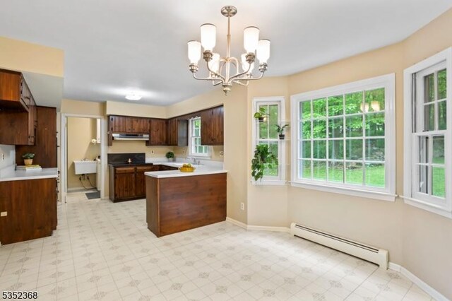58 Water St, Tewksbury Twp, NJ 08833 - kitchen featuring a baseboard radiator, a peninsula, light flooring, light countertops, and a chandelier